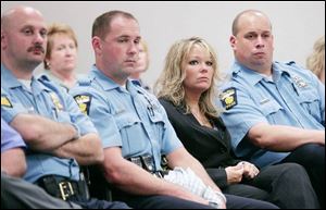 Danielle Dressel, widow of Detective Keith Dressel, joins offi cers at the hearing for the teen accused of killing her husband.
