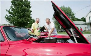 Donald Oates, from left, and Larry Rinehammer, both of Findlay, check out a 1963 Corvette Grand Sport owned by Mike Young of Gibsonburg. 
