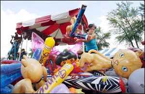 Liz Calton of Michael's Amusements sets up a booth at last year's Seneca County Fair in Tiffin. This year's dates are July 23-30.
<br>
<img src=http://www.toledoblade.com/assets/gif/weblink_icon.gif> SEARCH: <a href=
