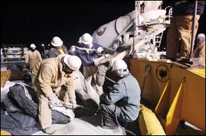 A group of workers seals the final segments of the bridge together in December, 2006. Linda Bowyer, an associate professor of finance at the University of Toledo, says the nearly $98 million in wages and benefits paid on the project produced benefits in Toledo and surrounding counties in the form of a spending spree.