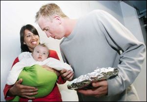 Mud Hens relief pitcher Jason Karnuth greets his wife, Rachel, and daughter Celia after a game.