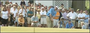 The large gallery around the ninth hole at Oakmont yesterday watches Bubba Watson chip out of the rough. Watson suffered a triple bogey on the hole during his round of 4-over 74.
