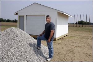 Rod Saunders as he prepared his property recently for the drive-in. Uprights for the screen are in the background. 