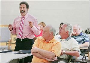 Oregon Councilman Jim Seaman questions a speaker during a meeting with FDS Coke Plant officials, who outlined how steam from the coking plant could be used to generate electricity.
