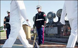 Marine Cpl. Craig Hampton, far right, stands at attention in front of the memorial.
<br>
(THE BLADE/AMY E. VOIGT)
<br>
<img src=http://www.toledoblade.com/graphics/icons/photo.gif> View View the <a href= 