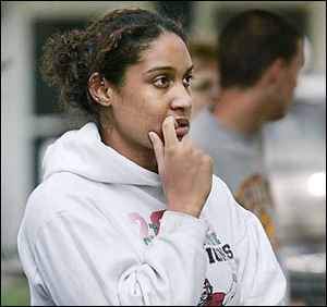 Brittany Katafiasz, 17, watches Toledo firefighters extinguish her home this morning.