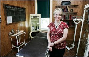 Beth Carr shows off the museum's operating room display, a relic from when the building was a hospital early in the 20th century. The building also housed Wauseon's first high school.