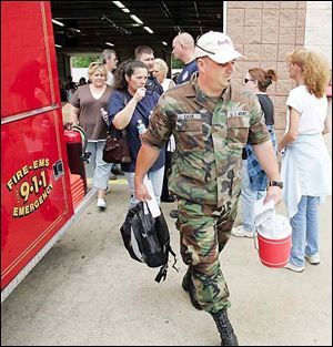 Eric Each leads volunteer searchers from the fire station in Uniontown, Ohio,  to search for Jessie Davis, a pregnant woman who disappeared last week.