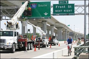 Signs are erected over the old I-280 bridge, which will remain in use for local traffic after the new span opens tomorrow.