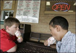 Victor Stahl, left, and Robert Rodriguez tackle cones at Chuggy's, where the owner says business is strong. 