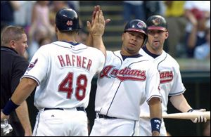 Travis Hafner and Jhonny Peralta high-five after scoring on Ryan Garko's double. Hafner also broke a home run slump.