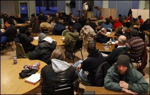 Guests listen to Chaplain Ernest Jackson. In the beginning, guests seeking shelter and services had to go to church.
