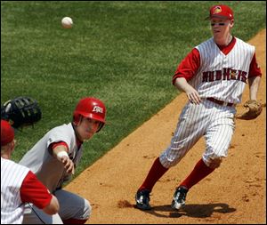 After Ottawa's Carlos Leon was caught off first base, Chris Shelton, left, and Kevin Hooper have him caught in a rundown.