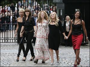 The reunited Spice Girls, Victoria Beckham, left, Melanie Chisholm, Geri Halliwell, Emma Bunton and Melanie Brown, pose today on the grounds of the Royal Observatory in London.