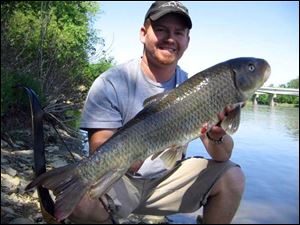 Toledoan Brent McGlone used a bow and arrow to take this record redhose sucker from the Maumee River near Waterville.