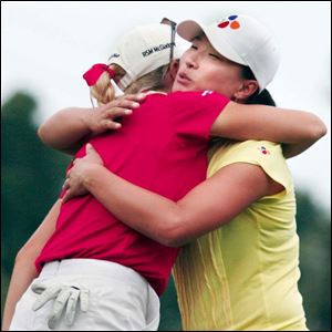 Natalie Gulbis, left, gives Se Ri Pak a hug after they finished the first round of the Farr Classic at Highland Meadows.
