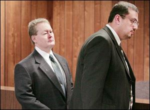 Charles V. Fackelman of Toledo and his attorney, Asad Farah, leave court after a pretrial hearing that will be rescheduled because the Monroe County prosecutor asked to be recused. 