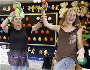 Slug: REG seneca26p A           The Blade/Jeremy Wadsworth     Date: 07/25/07                    Location: Tiffin, Ohio. Caption: Brooke Kistler, 12, of Tiffin, Ohio, gets her hand raised in victory by Cindy Stevens after winning a stuffed frog in a dart game Wednesday, 07/25/07, at the Seneca County Fair in Tiffin, Ohio.     Summary:  Fair theme: 