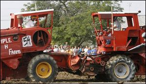 Brent Studenka, left, of Lyons, Ohio, rams the machine of Doug Miller of Delta, Ohio, during the combine demolition derby.
