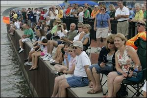 Fans in International Park watch as the boats make their way through the mighty Maumee.