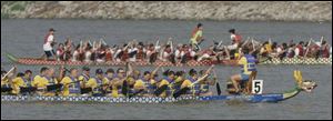 Kim Stoffel, at right in the front boat, keeps the rowers for the Kingston Health Care team on task during the Great Maumee River Dragon Boat festival. 