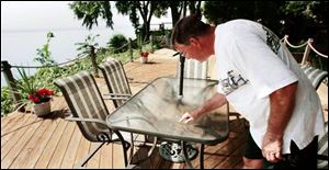 Bolles Harbor s Bob Rosenberger checks out the unusual powder that fell in the community Monday night. 
