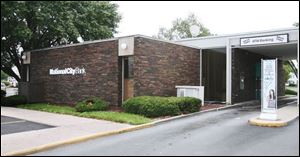 Two armed men wearing masks robbed the National City Bank branch on Manhattan Blvd.
about 10:45 a.m. A third suspect is believed to have been outside as a lookout, authorities said.
