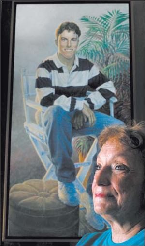 Lorraine Logsdon-Callis with a portrait of her son Adam.
