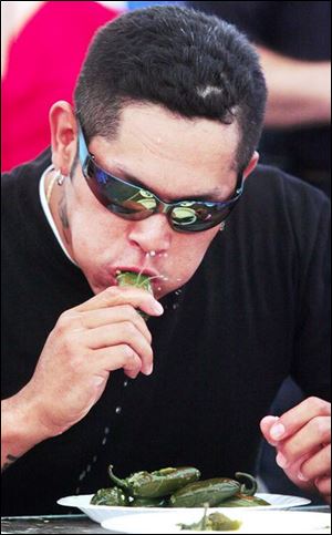 Slug: NBRS festival16p A          The Blade/Jeremy Wadsworth     Date: 08/11/07                      Location: Perrysburg Township, Ohio. Caption: Rosendo Rodriguez of Perrysburg Township wins a  jalapeno eating contest Saturday, 08/11/07, during the South of the Border Festival in the Perrysburg Heights neighborhood of Perrysburg Township. Rodriguez ate ten jalapenos for the win. Last year he won by eating fifteen jalapenos.   Summary: South of the Border Festival in the Perrysburg Heights neighborhood of Perrysburg Township.