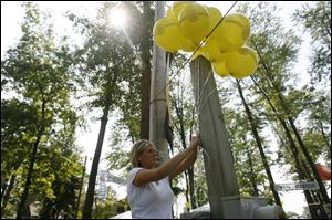 Abbey Hodulik, hangs balloons in the Biergarten as workers hurried to make sure everything was ready for the opening of the festival last night. Organizers have stocked the bier stubes with 24 varieties of beer.