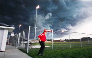 Jim Stover is the last person to leave the field as a storm looms over Rogers High School.
Several area high school football games were affected. 