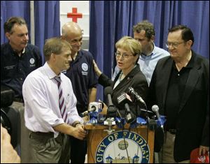 R. David Paulison, left, federal FEMA administrator, Michael Chertoff, U.S. Homeland Security secretary, U.S. Rep. Marcy Kaptur, Ohio Sen. Sherrod Brown, and U.S. Rep. Paul Gillmor discuss the flooding at a news conference.