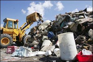 A mountain of trash grows at Emory Adams Park as 15 crews
have been busily picking up damaged goods from residences.