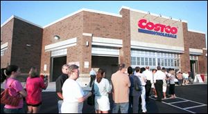 Shoppers wait in anticipation of the bargains inside on Costco s first day at Westgate Village Shopping Center.
