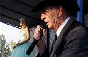 Junior fair queen contestant Katie Cole is introduced by Dave Thomas, the fair's operations and facility manager. 