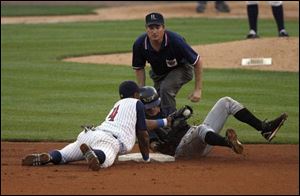 Hens second baseman Henry Mateo tags out Louisville's Luis Bolivar, who was trying to stretch a single into a double.
