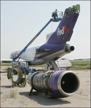 CTY plane30p 2  08/29/2007 BLADE PHOTO/Lori King  Worldwide Aircraft Recovery workers dismantle a plane donated to Owens Community College by Federal Express, at Metcalf Airport.