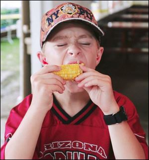 NBRE corn30p  Daniel Lambert, 11, of Lyons, at the festival. The Swanton Corn Festival offers rides, food, music and a car show in Memorial Park in Swanton, Ohio on August 25, 2007.  The Blade/Jetta Fraser.