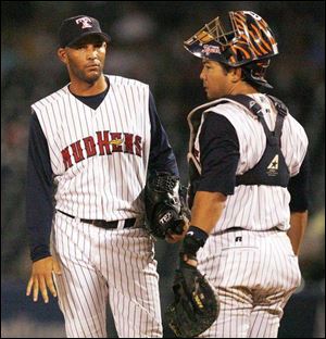 Hens pitcher Aquilino Lopez waits with catcher Dane Sardinha after Lopez gave up the game-deciding home run in the ninth.