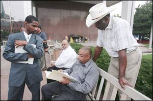 Preparing for a press conference yesterday were, from left, the Rev. Stephen Ward, Gary Daugherty, Dwayne Morehead, and the Rev. Alvin Griffin.