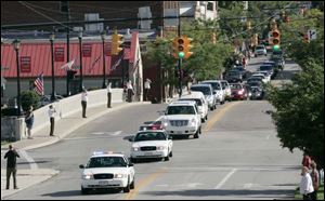 The cortege with the body of U.S. Rep. Paul Gillmor crosses the Sandusky River as it leaves downtown Tiffin for the cemetery.
