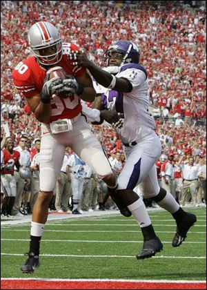 Brian Robiskie hauls in one of his three touchdown catches yesterday against Northwestern in Ohio Stadium.
