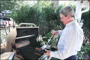 'Probably as the week went on, the thing that got my attention the most was trying to get the most nutritional value for the money,' says Commissioner Pete Gerken, grilling hamburgers for himself and his wife on the final day of the challenge. 