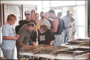 Autoworkers sign in at the UAW hall on Jackman Road. Many voiced surprise as well as determination about the strike.