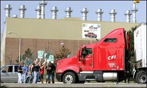 Autoworkers block a truck at a General Motors facility in Pontiac, Mich. About 73,000 GM workers went on strike nationwide.
