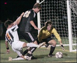 Jamie Dollar helps Perrysburg goalie Tim Ahlberg stop an attempt by Northview's Dan Cooperider. Ahlberg made seven saves in the second half after Tom Salmon made seven in the first.