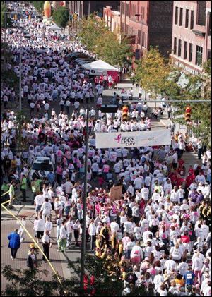 Runners and walkers fill the streets in downtown Toledo during the Race for the Cure.
