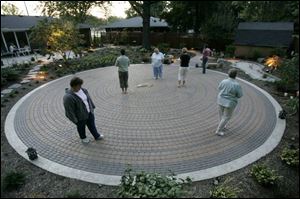 The visitors walk the labyrinth built in Mrs. Stark s backyard.