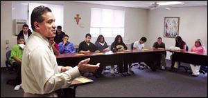 Business owner Greg Doss addresses students during Latino Career Day at Lourdes College.