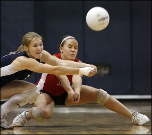 Seniors Chelsea Cox, left, and Katie Gosche attempt to return a serve. Gosche leads the the Raiders with 200 digs this season. 